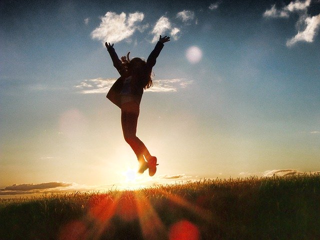 Woman jumps for joy at sunrise to celebrate a big lottery win